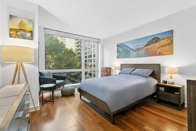 a bedroom with a bed and a large window