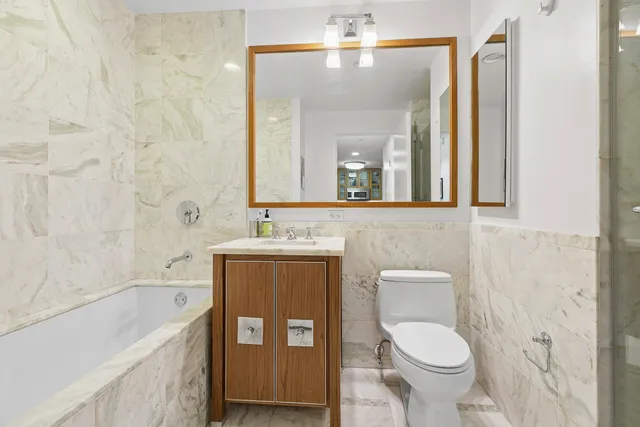 a bathroom with a toilet a sink and bathtub