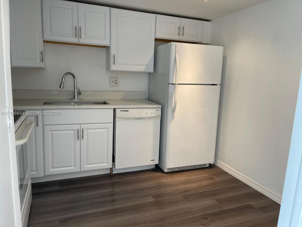 4174 Inverrary Drive, Unit 903 Lauderhill, FL 33319 - Photo 21 of 36 a white refrigerator freezer sitting inside of a kitchen