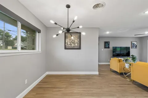 a view of a livingroom with furniture and flat screen tv