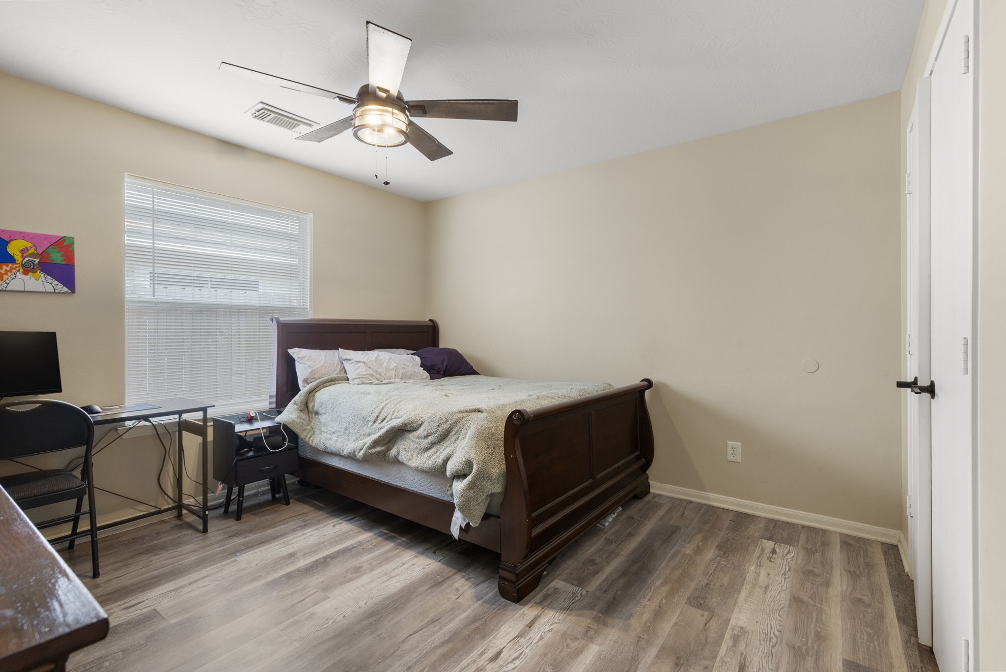 29106 Foxingham Circle Spring, TX 77386 - Photo 8 of 47 a bedroom with a bed and a chandelier