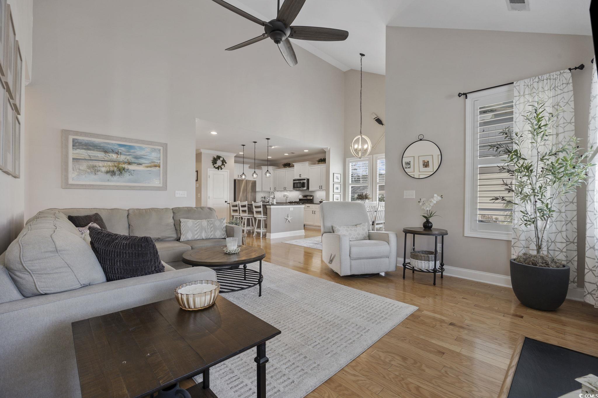 147 Hyacinth Loop Murrells Inlet, SC 29576 - Photo 10 of 40 Living room with a ceiling fan, light wood-style flooring, and high vaulted ceiling