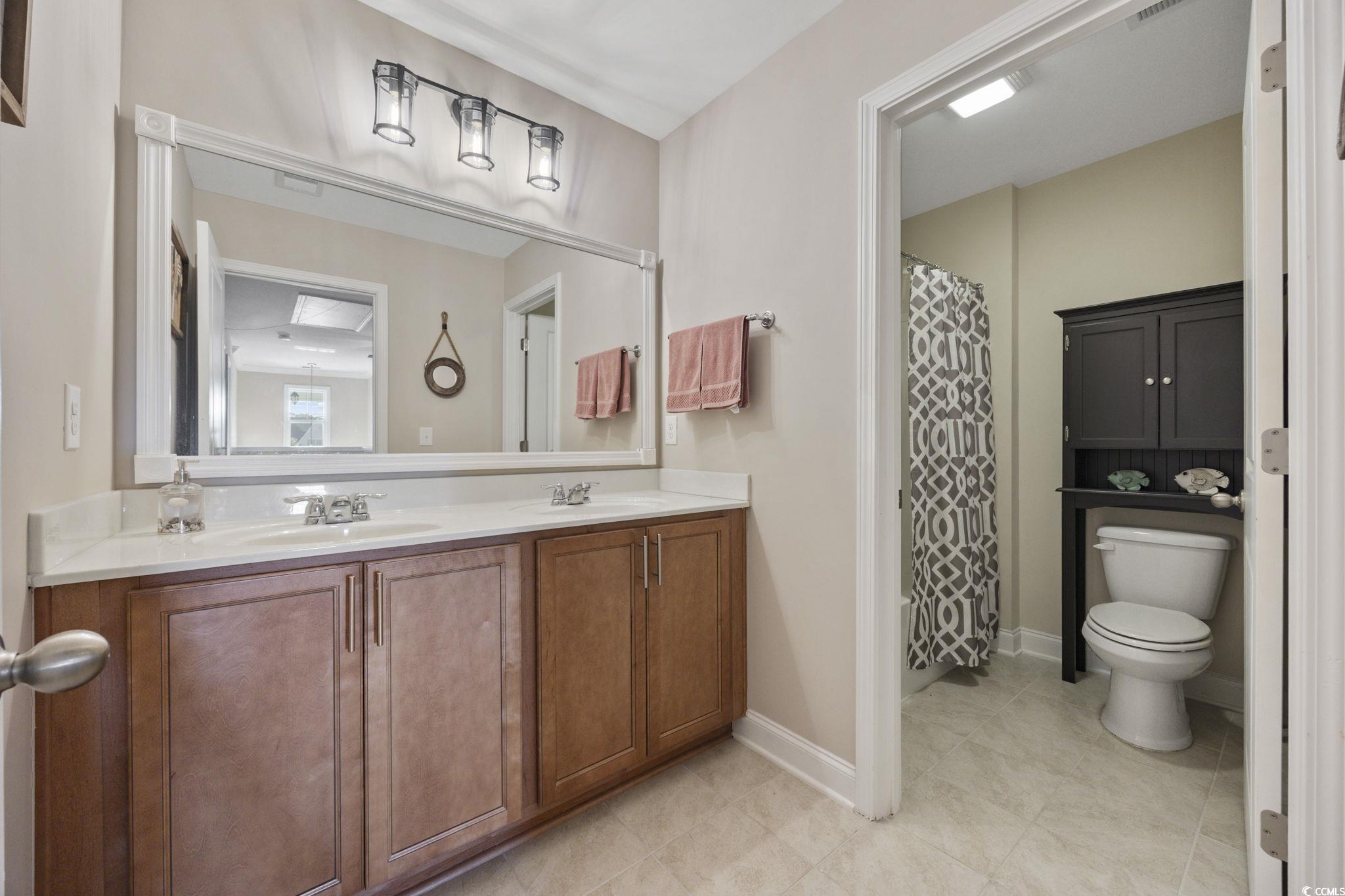 147 Hyacinth Loop Murrells Inlet, SC 29576 - Photo 23 of 40 Full bath with a shower with curtain and double vanity