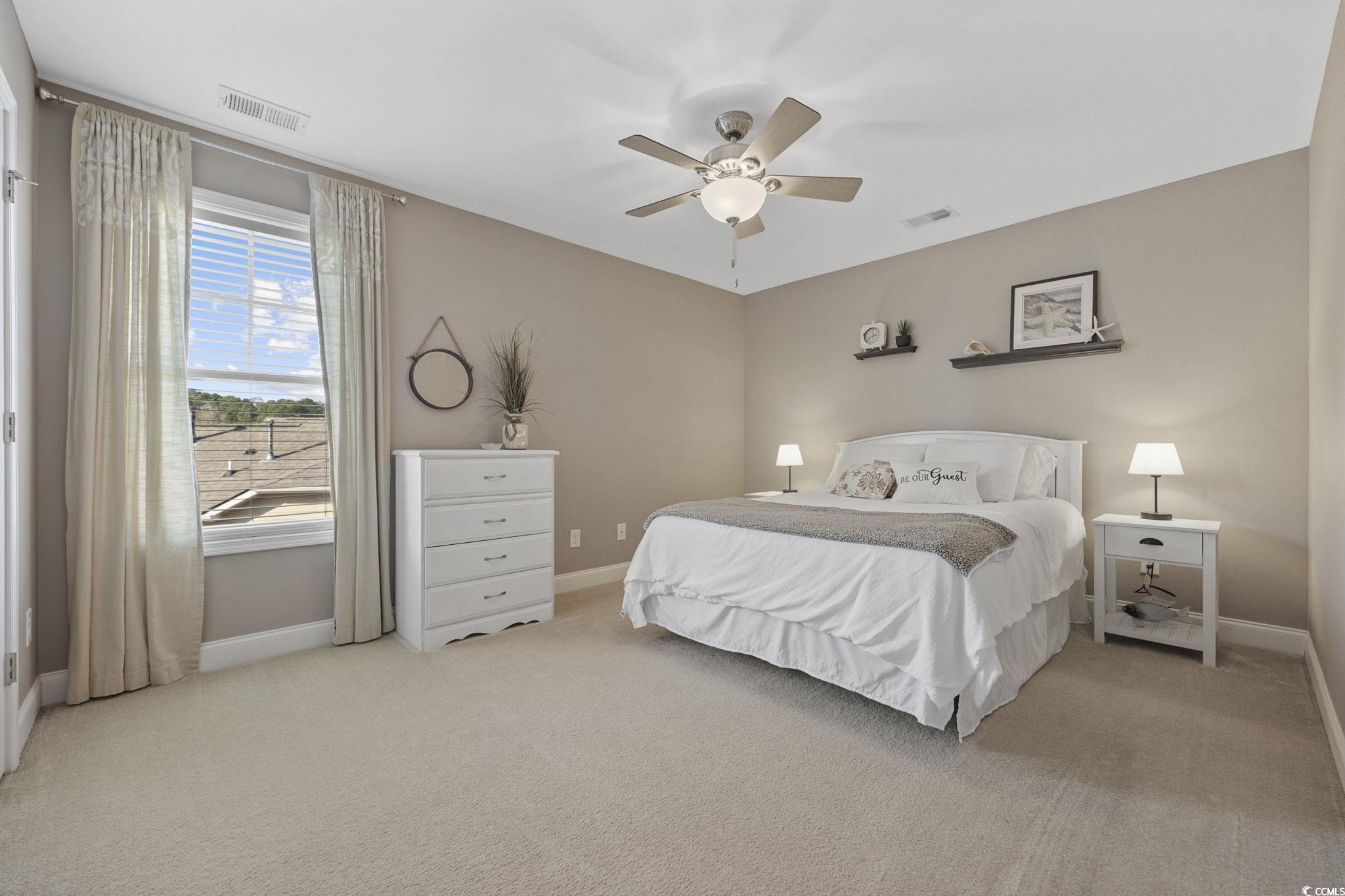 147 Hyacinth Loop Murrells Inlet, SC 29576 - Photo 24 of 40 Bedroom with light colored carpet and ceiling fan