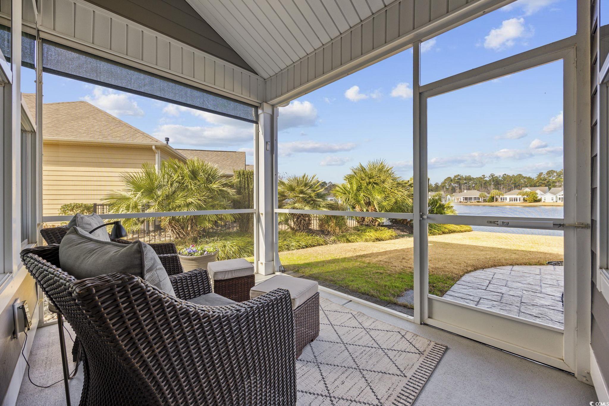 147 Hyacinth Loop Murrells Inlet, SC 29576 - Photo 27 of 40 Sunroom with a water view, healthy amount of natural light, and lofted ceiling