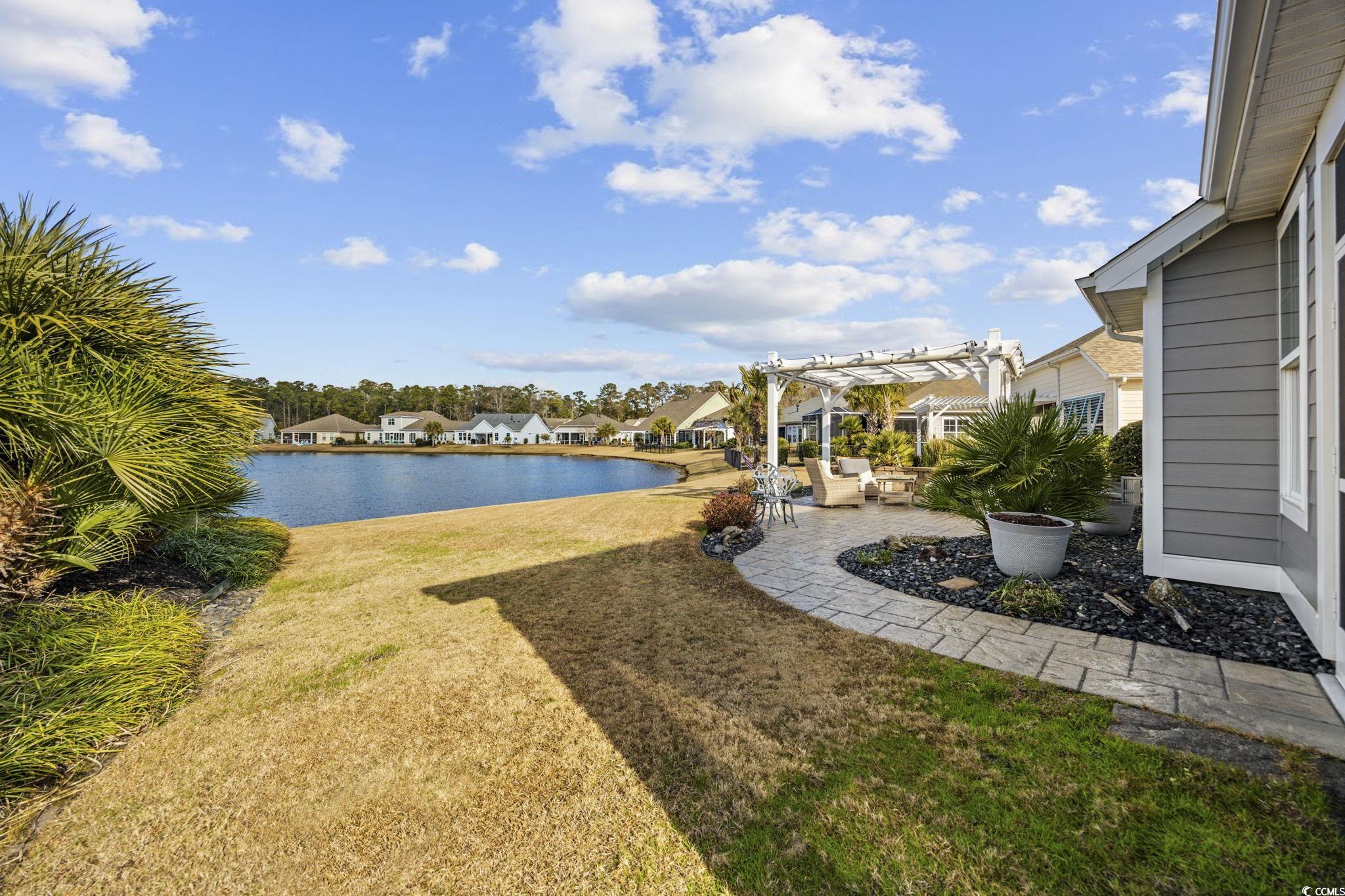 147 Hyacinth Loop Murrells Inlet, SC 29576 - Photo 28 of 40 View of grassy yard with a patio, a pergola, a water view, and a residential view