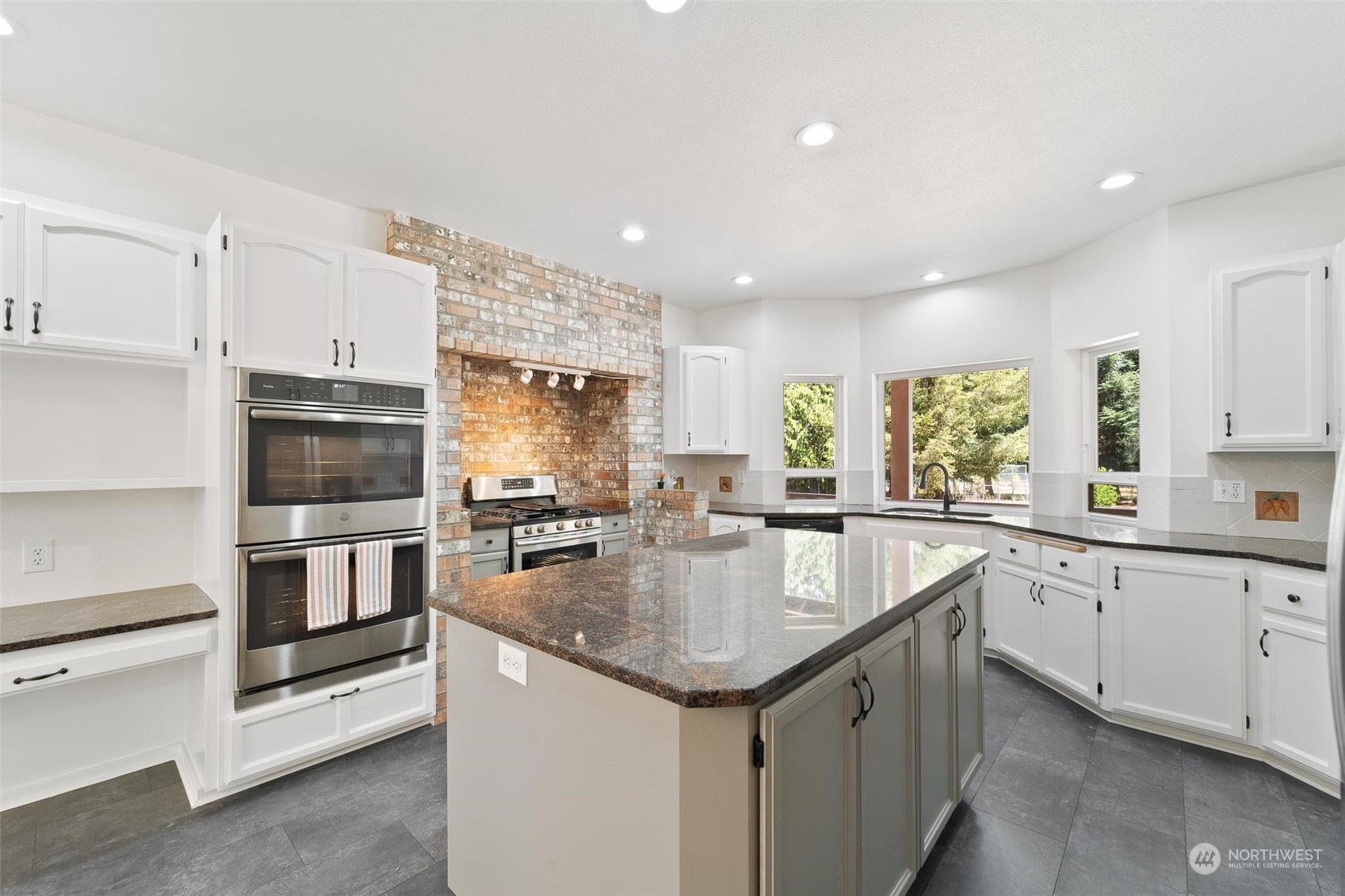 3321 Whiteman Road Southwest Longbranch, WA 98349 - Photo 14 of 40 a kitchen with granite countertop stainless steel appliances a stove sink and microwave