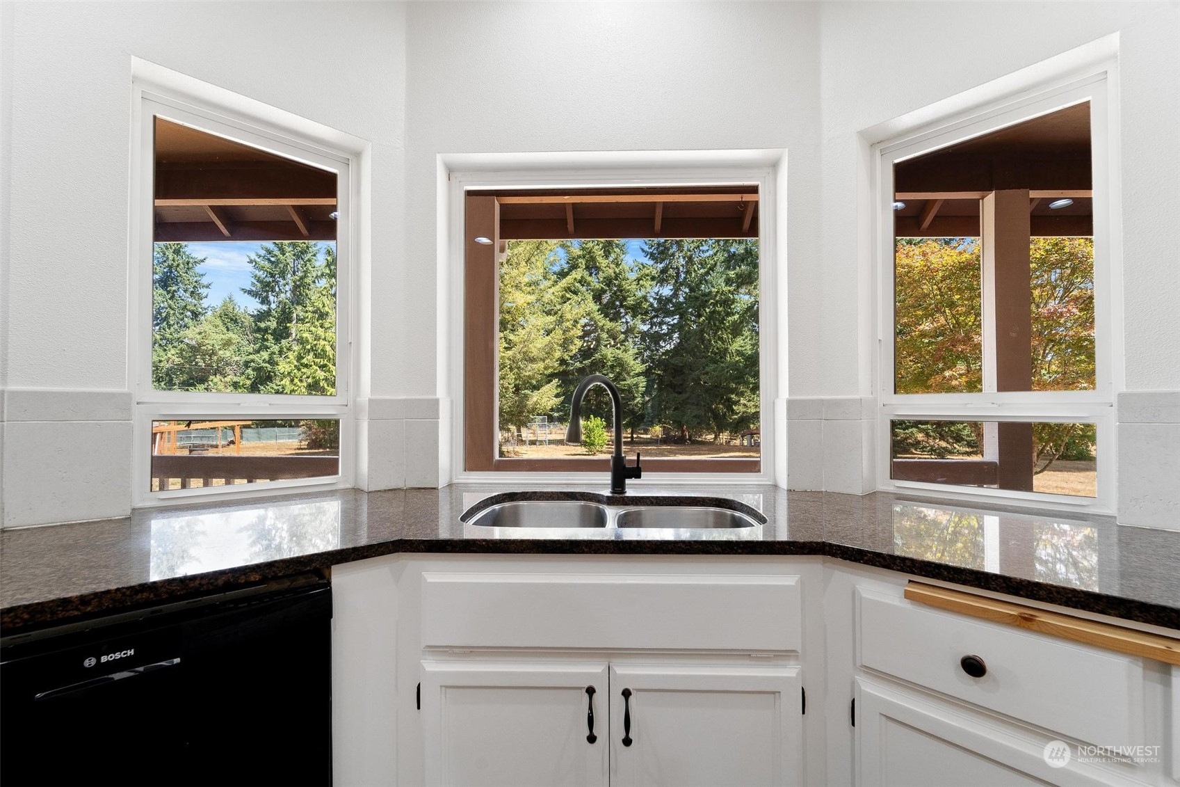 3321 Whiteman Road Southwest Longbranch, WA 98349 - Photo 15 of 40 a kitchen with stainless steel appliances a sink and a window