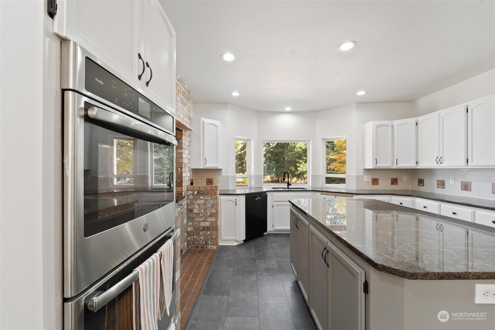 3321 Whiteman Road Southwest Longbranch, WA 98349 - Photo 18 of 40 a kitchen with stainless steel appliances granite countertop a sink and stove