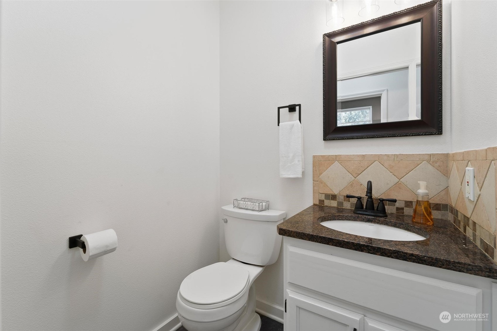 3321 Whiteman Road Southwest Longbranch, WA 98349 - Photo 21 of 40 a bathroom with a toilet a sink and mirror