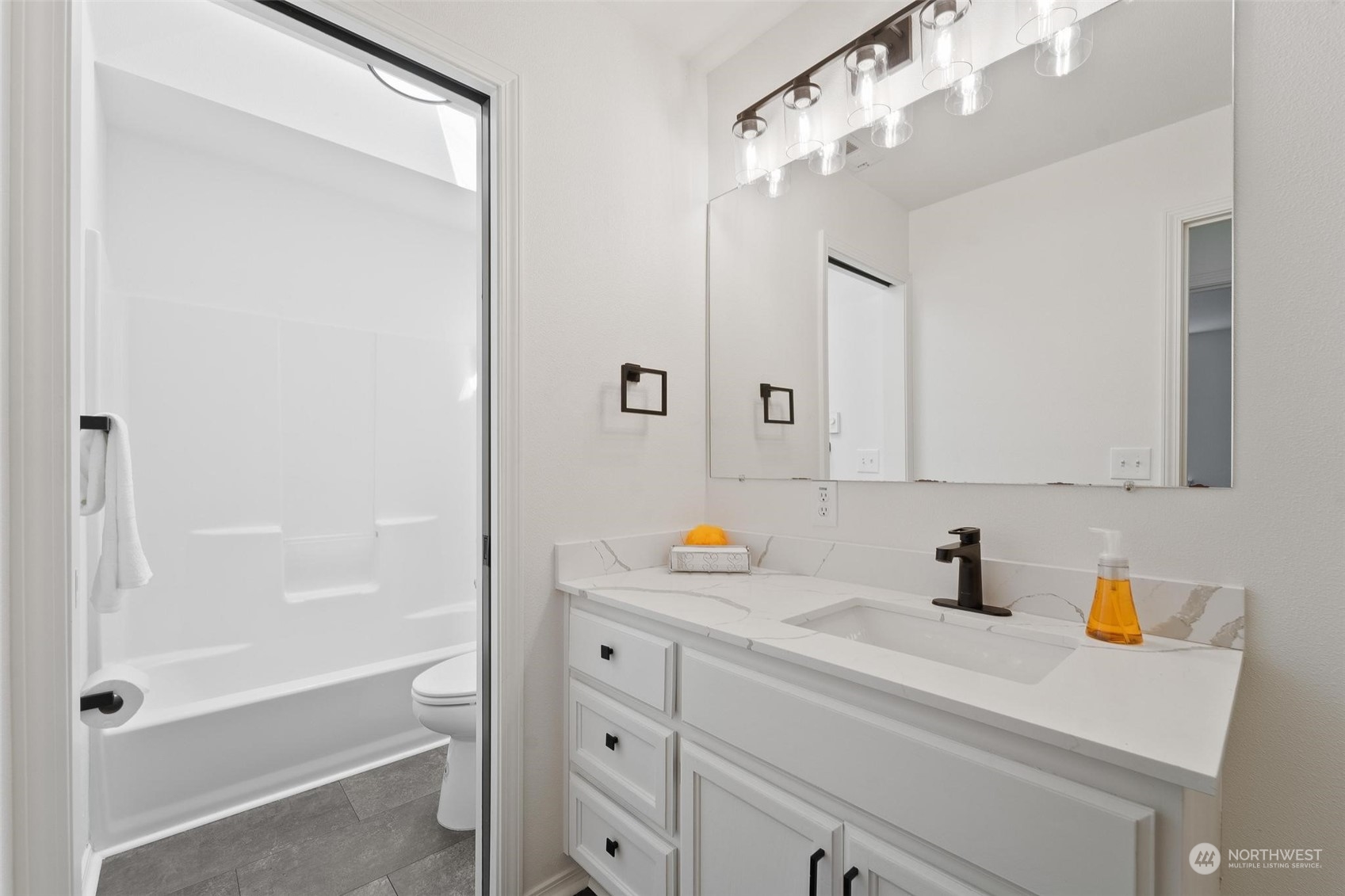 3321 Whiteman Road Southwest Longbranch, WA 98349 - Photo 29 of 40 a bathroom with a sink a vanity and shower