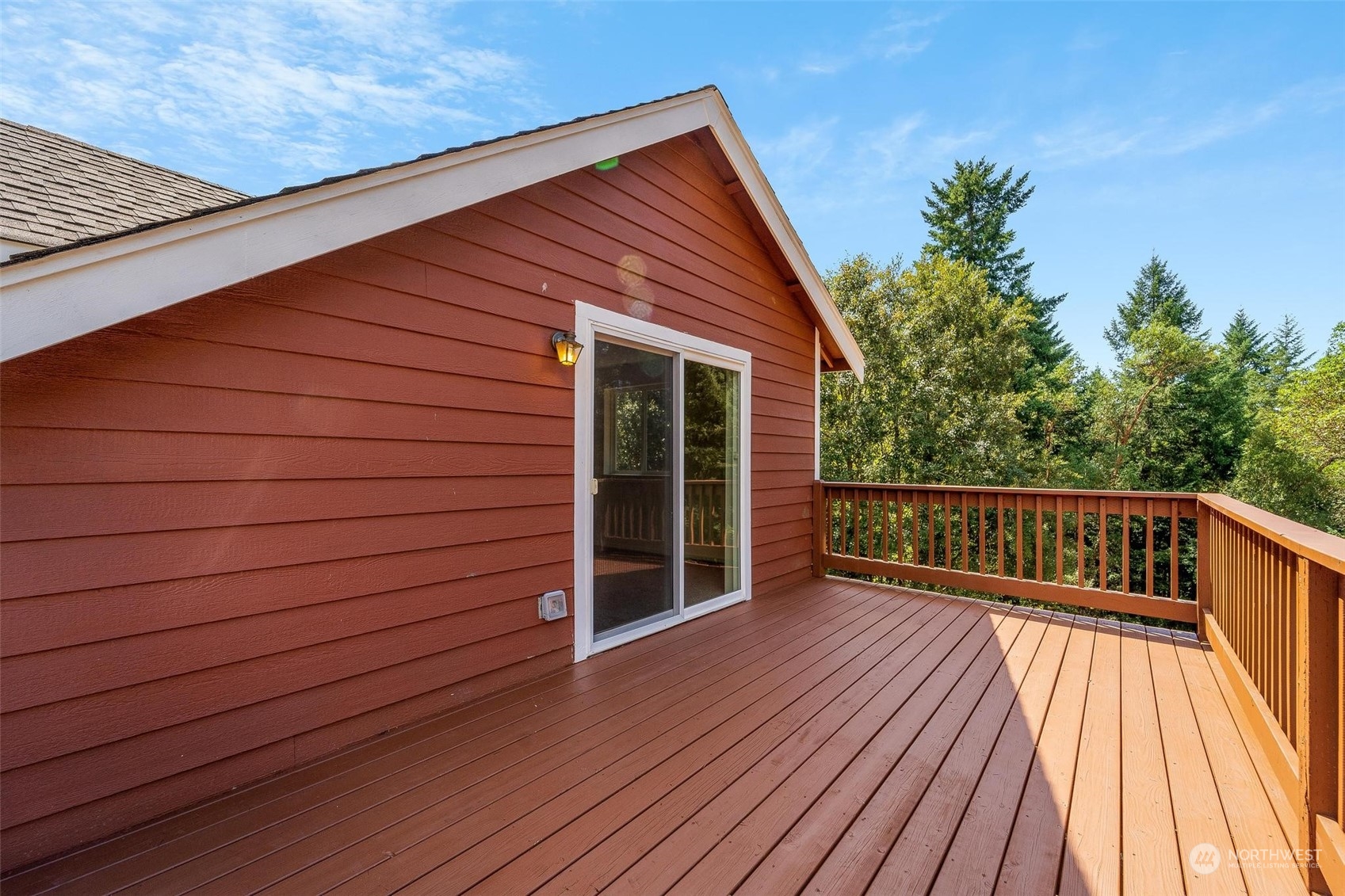 3321 Whiteman Road Southwest Longbranch, WA 98349 - Photo 34 of 40 a view of deck with wooden floor and fence and a floor to ceiling window
