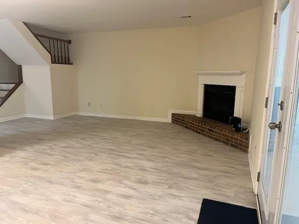 a view of a livingroom with wooden floor and a ceiling fan