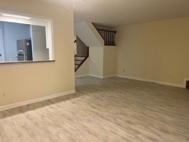 5950 WinterGreen Road Northwest Norcross, GA 30093 - Photo 17 of 33 a view of an empty room with wooden floor and a bathroom