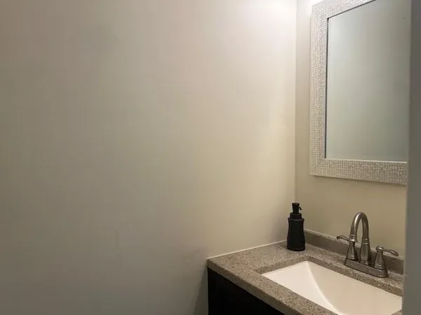 a bathroom with a sink and vanity