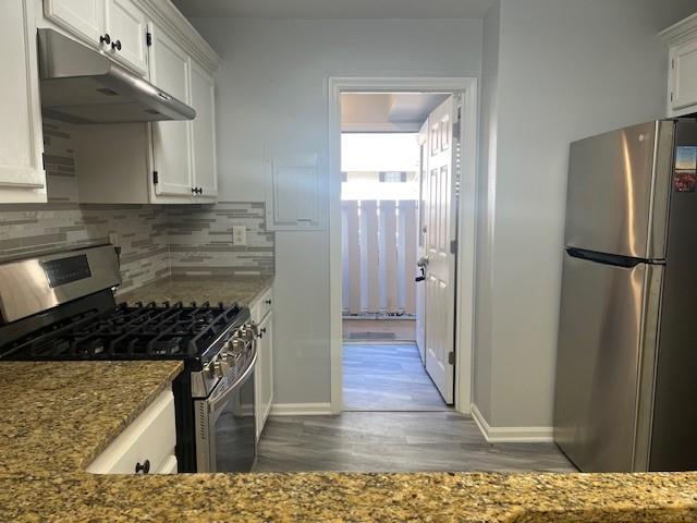 5950 WinterGreen Road Northwest Norcross, GA 30093 - Photo 21 of 33 a kitchen with a refrigerator and a stove top oven