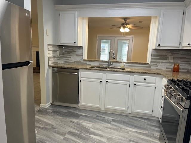 5950 WinterGreen Road Northwest Norcross, GA 30093 - Photo 22 of 33 a kitchen with stainless steel appliances granite countertop a stove a sink and a refrigerator