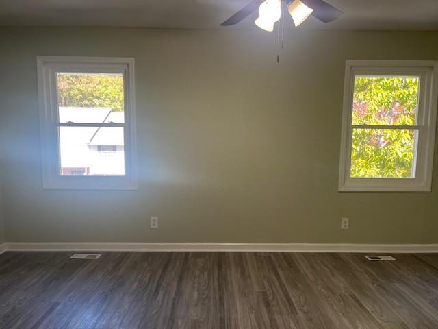 5950 WinterGreen Road Northwest Norcross, GA 30093 - Photo 28 of 33 an empty room with wooden floor and windows