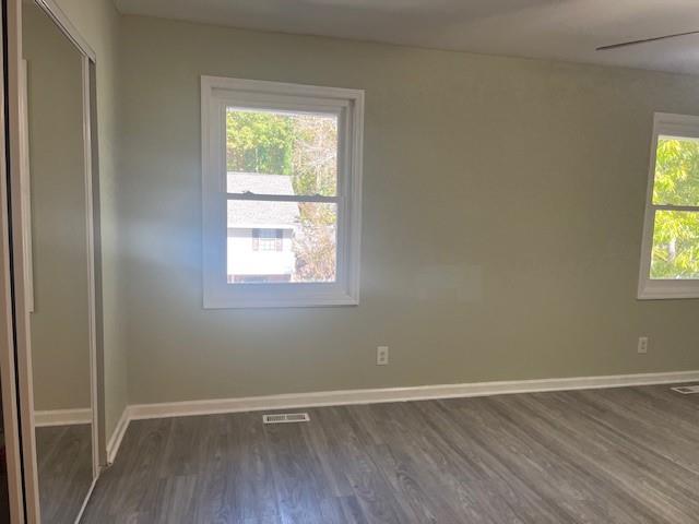 5950 WinterGreen Road Northwest Norcross, GA 30093 - Photo 29 of 33 an empty room with wooden floor and windows