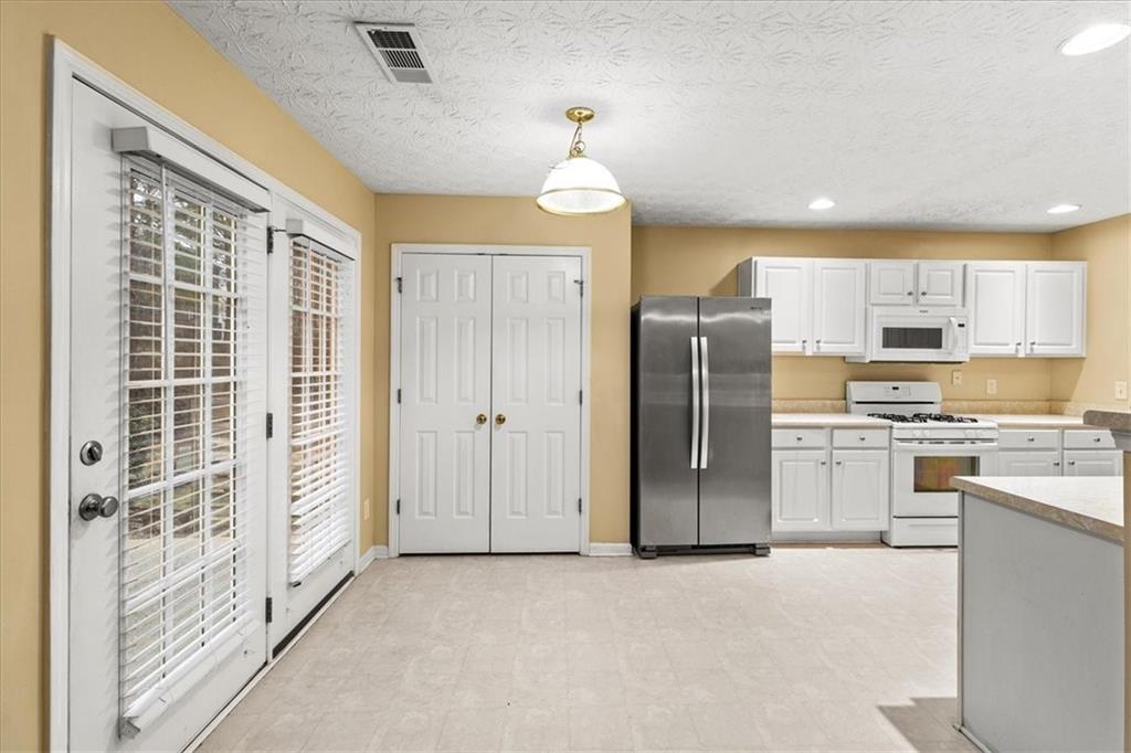 329 Meadows Lane Canton, GA 30114 - Photo 11 of 36 a view of a kitchen with a sink a refrigerator and window