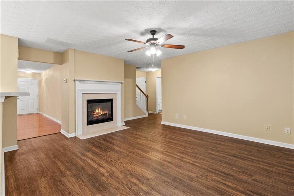 329 Meadows Lane Canton, GA 30114 - Photo 12 of 36 a view of an empty room with wooden floor and a fireplace