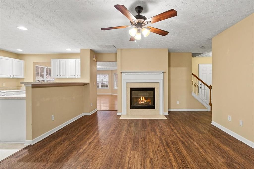 329 Meadows Lane Canton, GA 30114 - Photo 14 of 36 a view of a kitchen with wooden floor and a fireplace