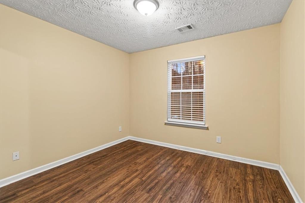 329 Meadows Lane Canton, GA 30114 - Photo 15 of 36 a view of an empty room with wooden floor and a window