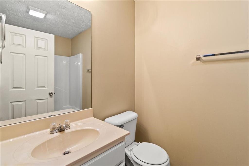 329 Meadows Lane Canton, GA 30114 - Photo 16 of 36 a bathroom with a sink a toilet and shower