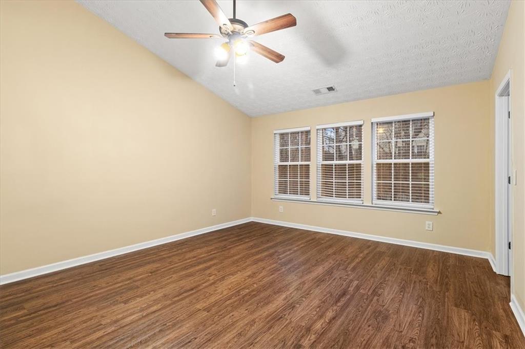 329 Meadows Lane Canton, GA 30114 - Photo 18 of 36 a view of an empty room with wooden floor and a window