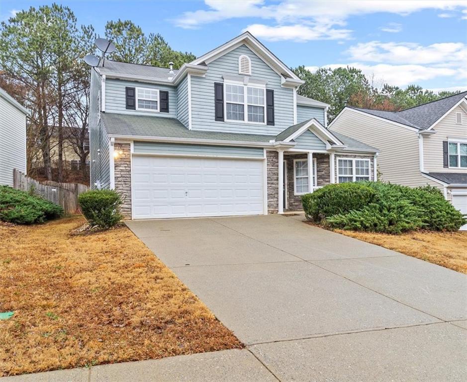 329 Meadows Lane Canton, GA 30114 - Photo 2 of 36 a front view of a house with a yard and garage