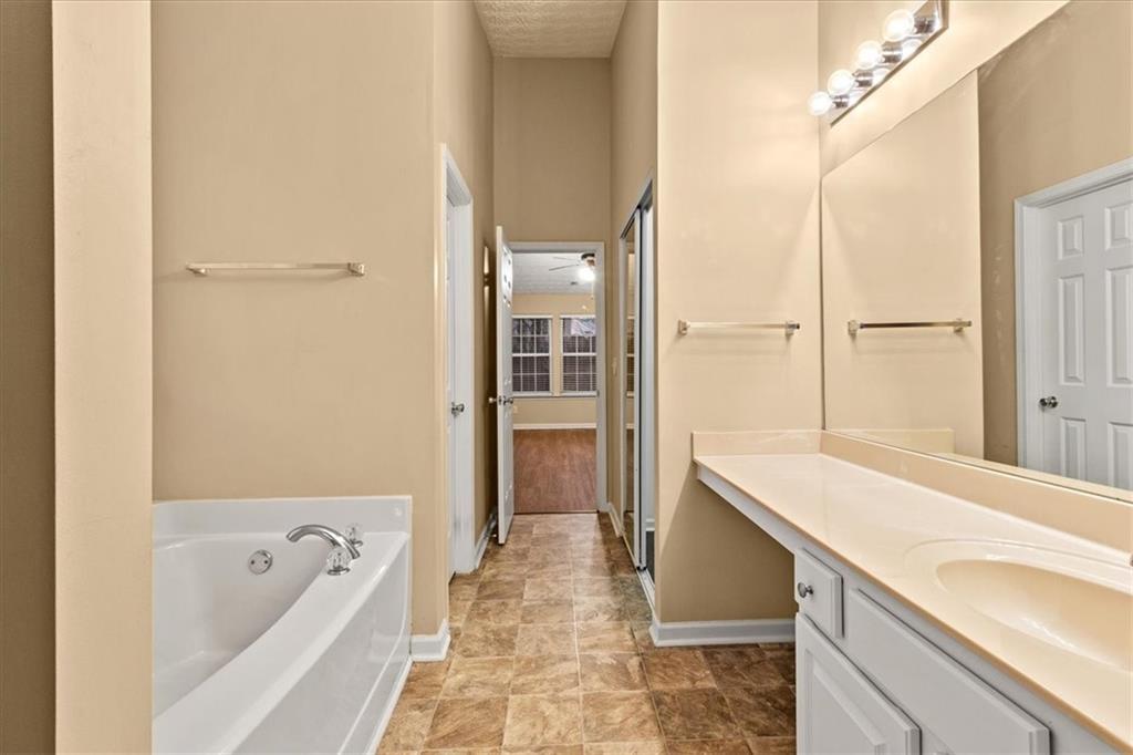 329 Meadows Lane Canton, GA 30114 - Photo 22 of 36 a spacious bathroom with a tub sink and mirror