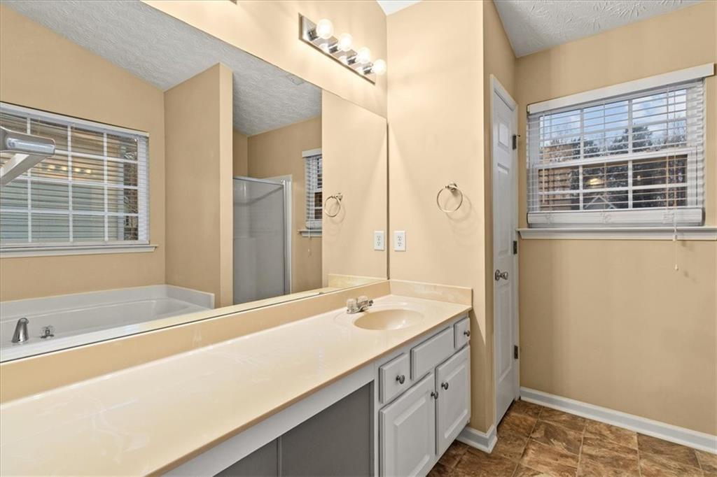 329 Meadows Lane Canton, GA 30114 - Photo 24 of 36 a bathroom with a sink and a bathtub