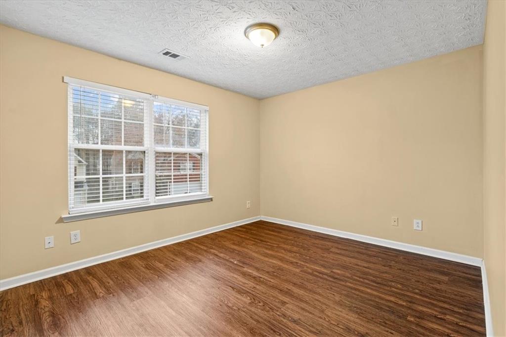 329 Meadows Lane Canton, GA 30114 - Photo 26 of 36 an empty room with wooden floor and windows