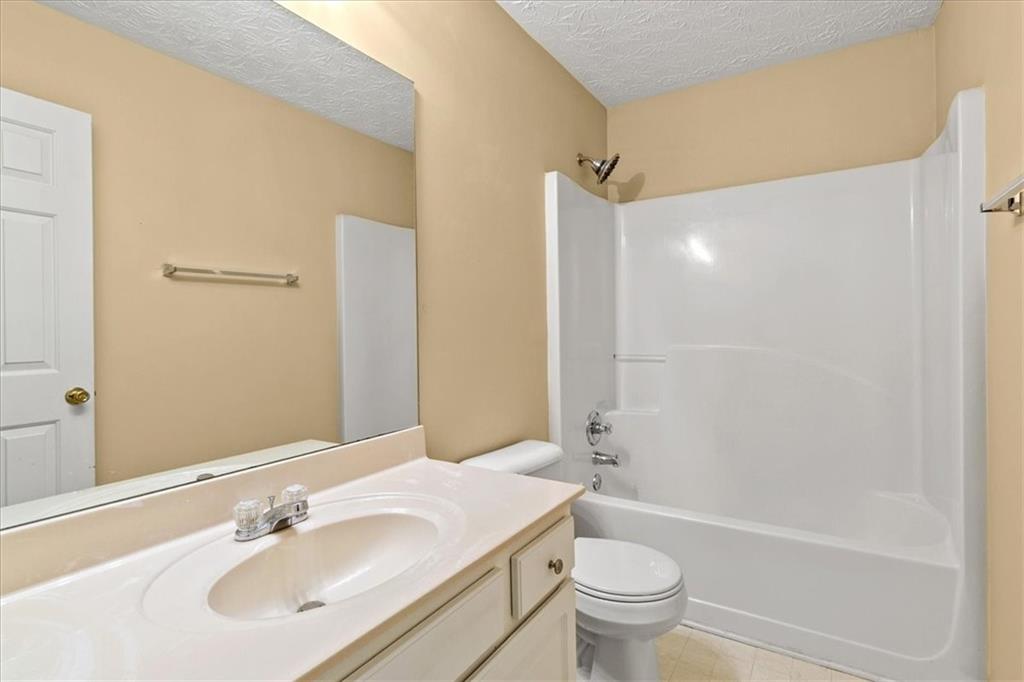 329 Meadows Lane Canton, GA 30114 - Photo 29 of 36 a bathroom with a sink a toilet and shower