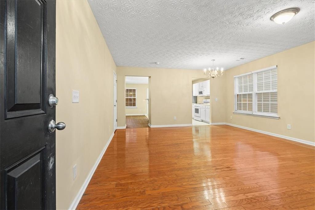 329 Meadows Lane Canton, GA 30114 - Photo 4 of 36 wooden floor in an empty room with a window