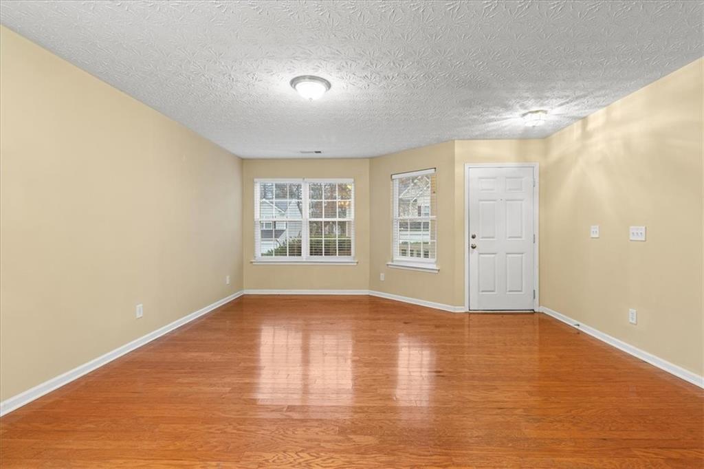 329 Meadows Lane Canton, GA 30114 - Photo 6 of 36 wooden floor in an empty room with a window