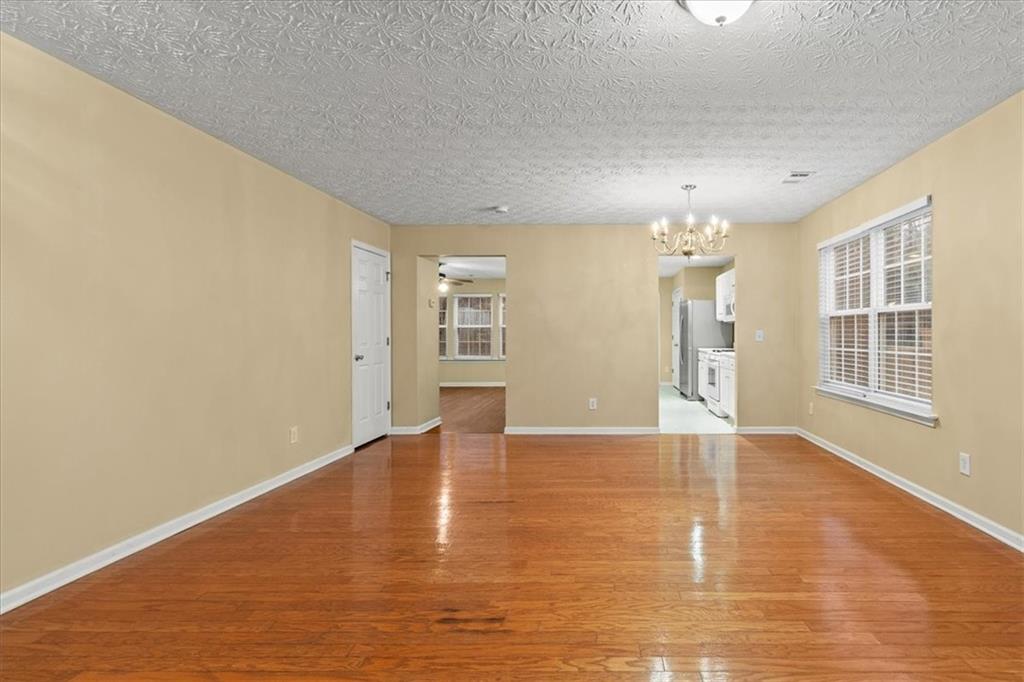 329 Meadows Lane Canton, GA 30114 - Photo 7 of 36 a view of an empty room with wooden floor and a window