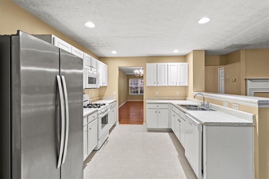 329 Meadows Lane Canton, GA 30114 - Photo 8 of 36 a kitchen with a sink stove and refrigerator