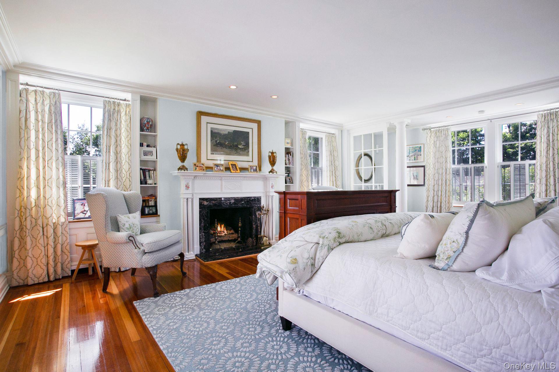 1 Roland Road Irvington, NY 10533 - Photo 13 of 35 a bedroom with a large bed and a fireplace