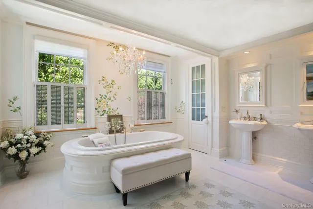 a living room with furniture and floor to ceiling windows
