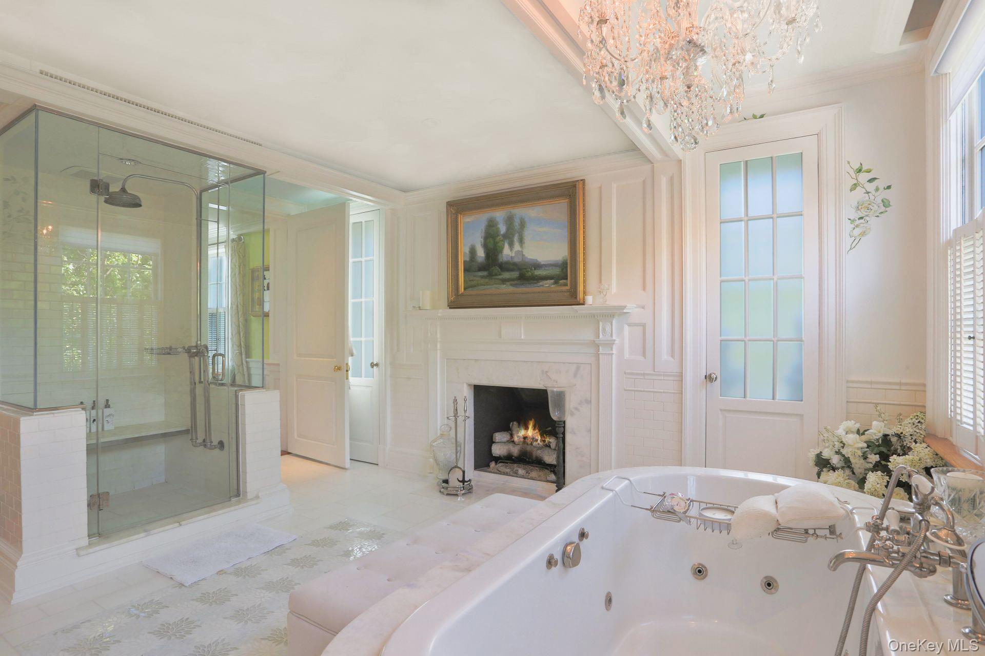 1 Roland Road Irvington, NY 10533 - Photo 17 of 35 a spacious bedroom with a bed and a chandelier