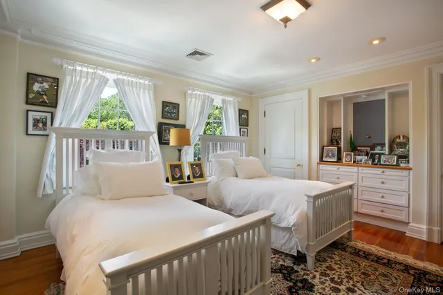 a bedroom with two beds and a large window