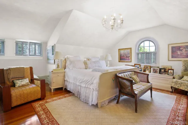 a bed room with furniture and a chandelier