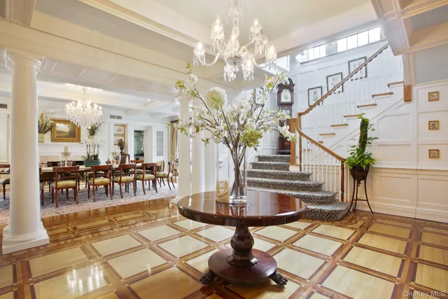 a view of hall way with furniture and chandelier
