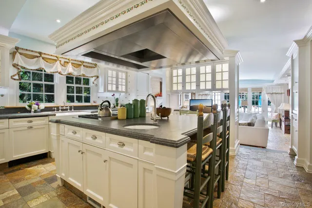a kitchen with stainless steel appliances granite countertop a sink and cabinets