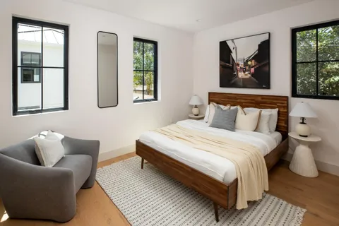 a bathroom with a granite countertop toilet a sink and mirror