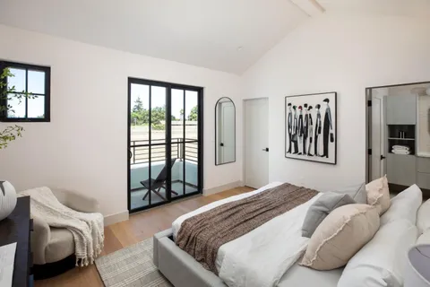 a bedroom with a large bed and a window