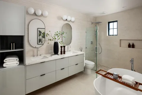 a bathroom with a double vanity sink mirror and toilet