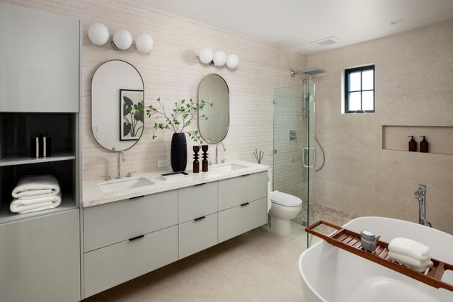 a bathroom with a double vanity sink mirror and toilet