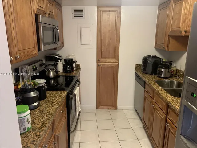 a view of a dining room with furniture and a kitchen view